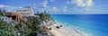 A Panoramic of Mayan ruins of Ruinas de Tulum (Tulum Ruins) and El Castillo at sunset, with beach and Caribbean Sea, in Quintana