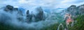 Panoramic Meteora mountains and Monastery of Roussanou rising out of the mist. Aerial, mystical panoramic landscape. UNESCO Royalty Free Stock Photo