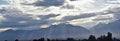 Panoramic misty view of angel rays from Sunrise and the Wasatch Front Rocky Mountain range looking East in Salt Lake City Utah in Royalty Free Stock Photo