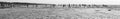 Panoramic monochrome seascape; running people