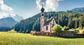 Panoramic morning view of San Giovanni Church in St. Magdalena village. Colorful summer scene of Funes Valley Villnob with Odle