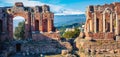 Panoramic morning view of Taormina town and Etna volcano on background. Splendid spring scene of ancient Greco-Roman theater, Sici