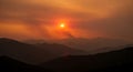 panoramic mountain view with forest fire smoke and sunset Royalty Free Stock Photo