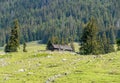 Panoramic mountain view with a small cabin