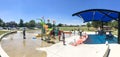 Panoramic multicultural kids and parent playing at splash park in Texas in post COVID-19 pandemic