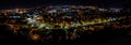 Panoramic night cityscape view with illuminated Cluj-Napoca city and trees Royalty Free Stock Photo