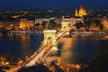 Panoramic night view of Budapest. Illuminated Chain Bridge reflected in Danube River Royalty Free Stock Photo