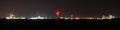 Panoramic night view of oil refinery buildings, towers and pipes