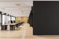 Panoramic office with places for work, wooden floors and empty black wall Royalty Free Stock Photo