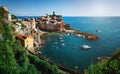 Panoramic overview of Vernazza village with colorful houses on bright summer sunny day, Cinque Terre National Park, La Spezia Royalty Free Stock Photo