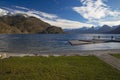 Panoramic peaceful picturesque landscape country side scenic view lake waterfront jetty wooden pier on lake water with Alps Royalty Free Stock Photo