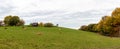 Panoramic photo of autumn field and village. German rural landscape