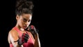 Panoramic photo of beautiful fighter woman over black background