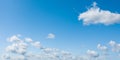 Panoramic photo of a clear blue sky and white clouds over horizon Royalty Free Stock Photo