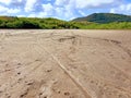 Panoramic photo of dry salt pans of ocher color. Blue sky with tropical clouds and mountains with vegetation. Martinique, French Royalty Free Stock Photo