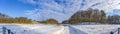 Panoramic photo of the snowy meadow and in the background the Seringenberg with the lookout tower in the De Horsten park in Wassen