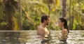 Couple in Love Together in Infinity Swimming Pool Outdoors During Tropical Vacation Royalty Free Stock Photo