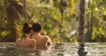 Couple in Love Together in Infinity Swimming Pool Outdoors During Tropical Vacation Royalty Free Stock Photo