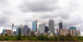 Panoramic picture of the city of Sydney`s skyline and skyscrapers. Cloudy sky. High concrete buildings and nature. Sydney, New