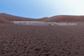 Panoramic picture of the Deadvlei salt pan in the Namib Desert with dead trees in front of red sand dunes in the morning light Royalty Free Stock Photo