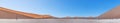 Panoramic picture of the Deadvlei salt pan in the Namib Desert with dead trees in front of red sand dunes in the morning light Royalty Free Stock Photo