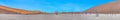 Panoramic picture of the Deadvlei salt pan in the Namib Desert with dead trees in front of red sand dunes in the morning light Royalty Free Stock Photo