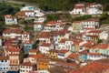 Panoramic picture of white houses and colorful houses built on the hill. Vertical town, narrow streets. Traditional red and orange Royalty Free Stock Photo