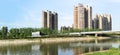 Panoramic reflection of riverbank trees, buildings and bridges Royalty Free Stock Photo