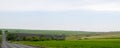 Panoramic road through plowed fields Royalty Free Stock Photo