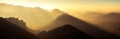 Panoramic scenic view of mountains and hills silhouette at sunset