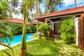 Panoramic scenic view of nice villa. Swimming pool in tropical hotel or vacation home Royalty Free Stock Photo