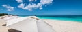 Panoramic sea and beach view with sun umbrellas on a white sand beach in the Caribbean. Royalty Free Stock Photo