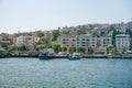 Panoramic sea view of the resort town with houses in the mountains and a pier with boats on a Adalar Islands