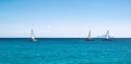 Panoramic sea view with three sailing boats cruising on the ocean. Royalty Free Stock Photo