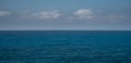 Panoramic seascape with clouds on the horizon. Blurry ocean seascape, serene and peaceful.