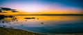 Panoramic seascape of glowing sunset over calm ocean bay water. Royalty Free Stock Photo