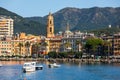 Panoramic seashore view of the Italian city overlooking the Mediterranean sea with houses and church, businesses and boats moored Royalty Free Stock Photo