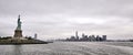 Panoramic shot of the amazing Statue of Liberty on New York city background Royalty Free Stock Photo