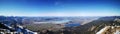 Panoramic shot of a beautiful mountainous landscape with a lake on a sunny day Royalty Free Stock Photo