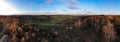 Panoramic shot of the beautiful trees on a field under the cloudy sky Royalty Free Stock Photo