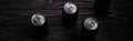 Panoramic shot of black aluminum cans of beer on wooden table with copy space.