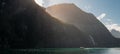 Panoramic shot of boat sailing through fiord Royalty Free Stock Photo