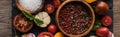 Panoramic shot of bowls with pepper and salt near chilli pepper, spinach, sliced tomatoes and garlic on black tray on Royalty Free Stock Photo