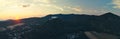 Panoramic shot of the Castle of Fuzer in Hungary with the mountains and the sunset in the background