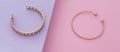 Panoramic shot of Chain and spiral shape bracelets on pink and purple background Royalty Free Stock Photo