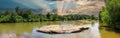 A panoramic shot of the Chattahoochee river with rocks on the middle of the river and green trees reflecting off the water Royalty Free Stock Photo