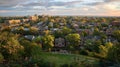 A panoramic shot of a citys residential neighborhoods featuring rows of houses and apartment buildings. Parks