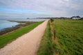 Panoramic shot of the coastal landscape with rural dirt road in Amrum, North Sea, Germany
