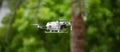 Panoramic shot of a DJI Mavic Mini 2 drone on the blurry background