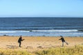 Panoramic shot of father and son playing flying disc on the beach of North Berwick a seaside town Royalty Free Stock Photo
